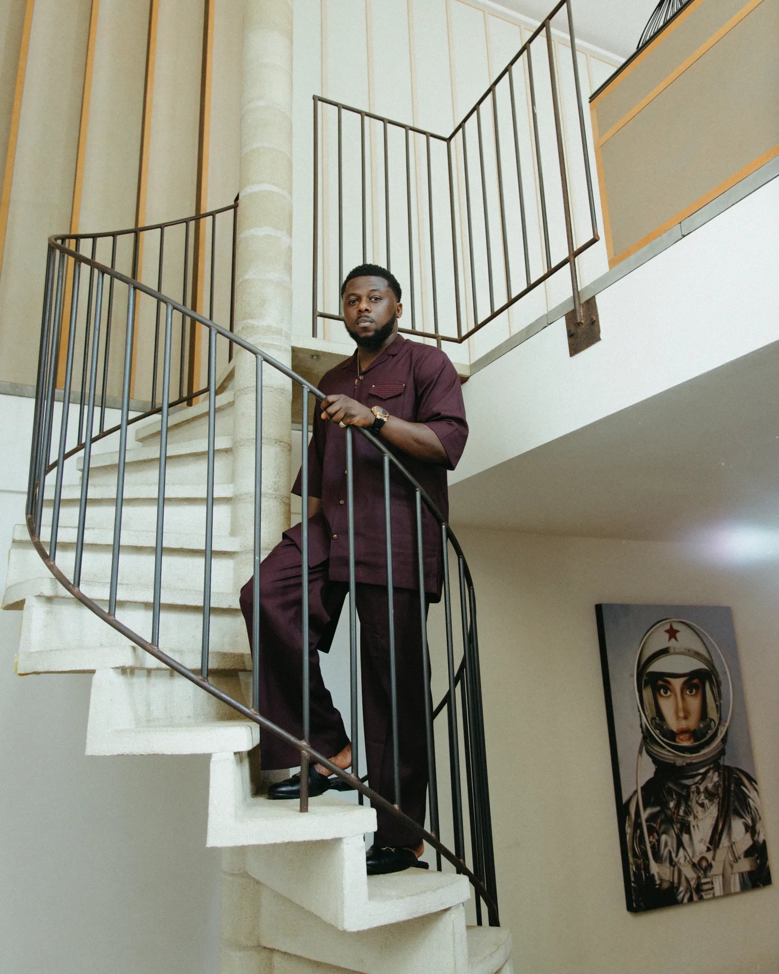 Timi, founder of ALPAC London, standing on a spiral staircase.